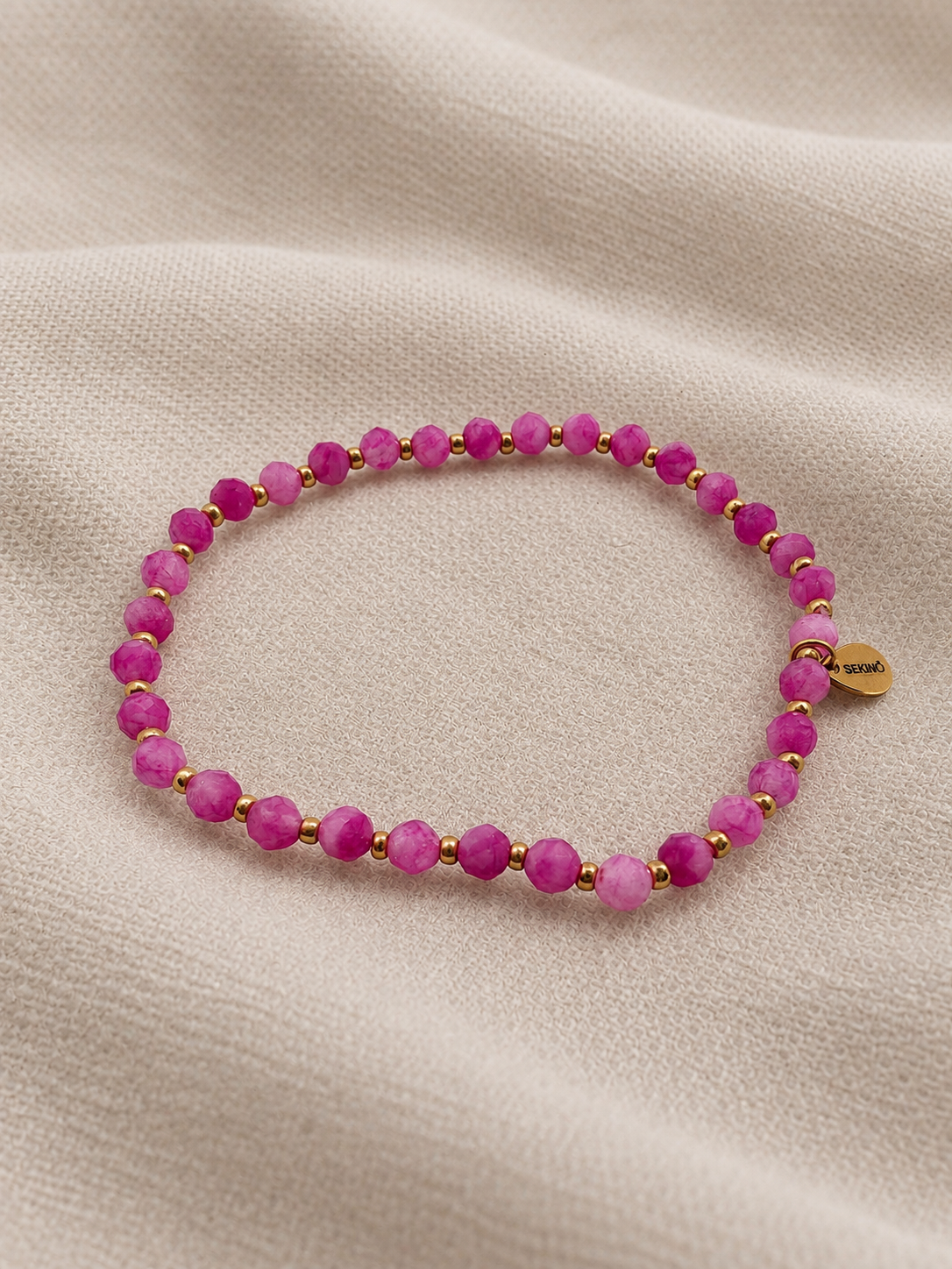 SEKINO Radiance Armband mit facettierten Fuchsia Quartz Steinen und goldfarbenen Details